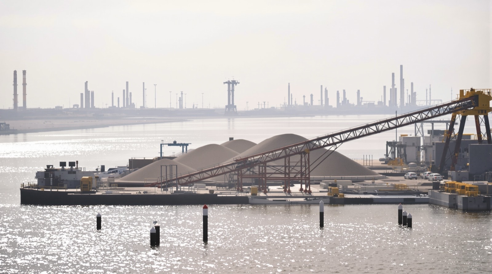Imported crushed stone being unloaded at an industrial waterway terminal